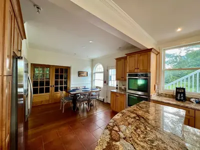 a kitchen with a table and a dining room at Hill Farm Inn - Manchester in Sunderland