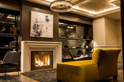 a living room with a fireplace and a yellow chair at Hotel 32 32 in New York