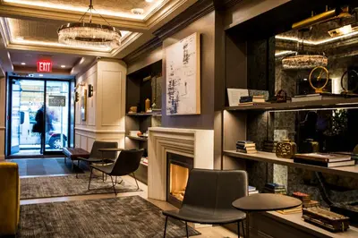 a lobby with chairs and a fireplace in a store at Hotel 32 32 in New York