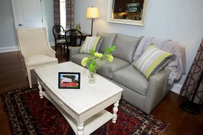 a living room with a couch and a table at Guest House at Norwalk Inn in Norwalk