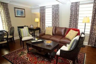a living room with a couch and a table at Guest House at Norwalk Inn in Norwalk