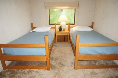 two twin beds in a room with a window at 4BD 2BA - Mount Snow VT - Ski-Back Trail - Shuttle in Dover