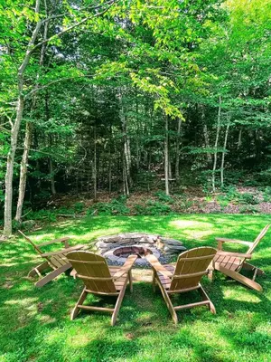 two chairs and a fire pit in the grass at 4BD 2BA - Mount Snow VT - Ski-Back Trail - Shuttle in Dover