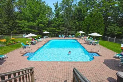 a swimming pool with a person in the water at 4BD 2BA - Mount Snow VT - Ski-Back Trail - Shuttle in Dover