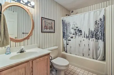 a bathroom with a sink and a toilet and a shower curtain at Timber Creek Townhome with 2 Decks and Mtn Views! in West Dover