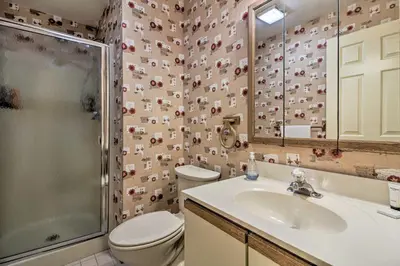 a bathroom with a toilet and a sink and a shower at Timber Creek Townhome with 2 Decks and Mtn Views! in West Dover
