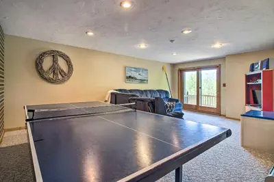 a living room with a ping pong table at Timber Creek Townhome with 2 Decks and Mtn Views! in West Dover