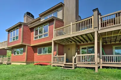 a large house with decks on the side of it at Timber Creek Townhome with 2 Decks and Mtn Views! in West Dover