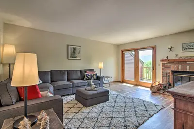 a living room with a couch and a fireplace at Timber Creek Townhome with 2 Decks and Mtn Views! in West Dover