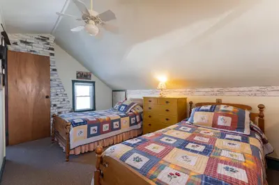 a bedroom with two beds and a ceiling fan at Saratoga Farmstead B&B in Saratoga Springs