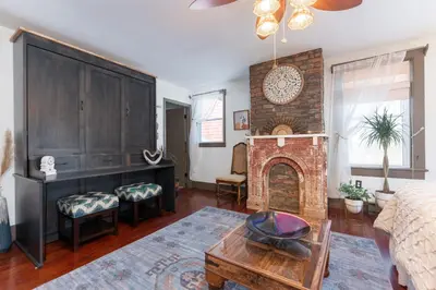 a living room with a brick fireplace and a couch at Saratoga Farmstead B&B in Saratoga Springs