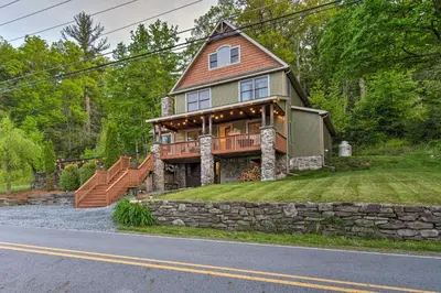 a large house with a stone wall at Large Yard and Games Edgewater Escape in Paupack! in Paupack