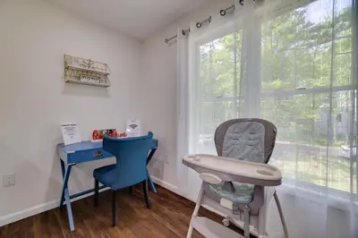 a room with a chair and a desk and a window at 2 Game Rooms! Family Poconos Home 9 Mi to Slopes in Pocono Summit
