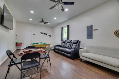 a living room with a couch and a table and chairs at 2 Game Rooms! Family Poconos Home 9 Mi to Slopes in Pocono Summit