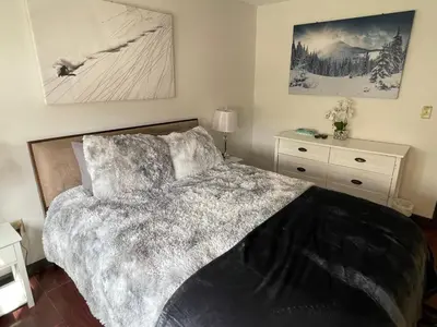 a bedroom with a bed and a dresser at Gorgeous Ski On/Off 2 BR Sleeps 8 Jiminy-Must See Luxury in Hancock