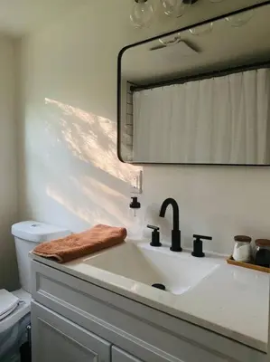 a bathroom sink with a large mirror above it at The Cabin @ Benton Hollow in Livingston Manor