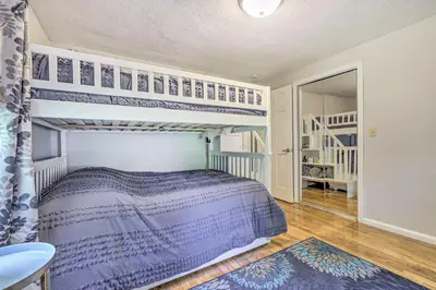 a bedroom with a bunk bed and a staircase at Granby Getaway in the Woods with Spacious Yard! in Granby