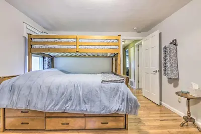 a bedroom with a bed with a wooden bed frame at Granby Getaway in the Woods with Spacious Yard! in Granby