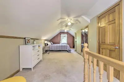 a bedroom with a bed and a ceiling fan at Granby Getaway in the Woods with Spacious Yard! in Granby