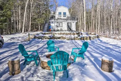 a group of chairs in the snow in front of a house at Wilmington Chalet with Hot Tub Less Than 8 Mi to Mount Snow! in Wilmington