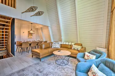a living room with couches and a dining room at Wilmington Chalet with Hot Tub Less Than 8 Mi to Mount Snow! in Wilmington
