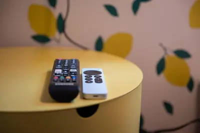 two remote controls sitting on top of a table at The Flat NYC in New York