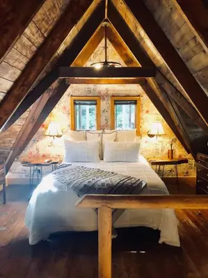a bedroom with a large bed in a attic at Bear Cottage in Birchwood Lakes