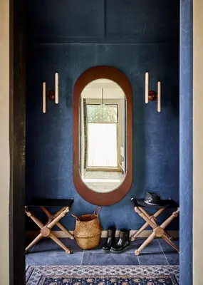 a blue room with a mirror and a basket and shoes at Wildflower Farms, Auberge Collection in Gardiner