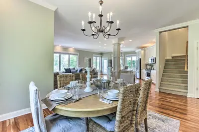 a dining room and living room with a table and chairs at Elegant Middlefield Getaway with Game Room! in Middlefield