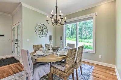 a dining room with a table and chairs and a window at Elegant Middlefield Getaway with Game Room! in Middlefield