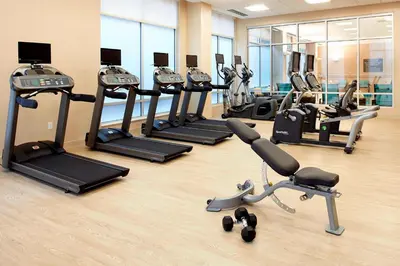 a gym with a row of treadmills and exercise bikes at Residence Inn by Marriott Secaucus Meadowlands in Secaucus