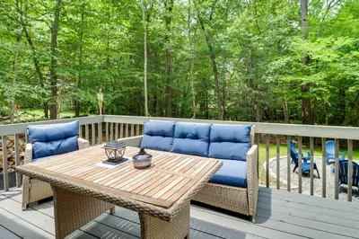 a patio with a table and chairs on a deck at Near Skiing and Hiking Gouldsboro Home with Hot Tub in Gouldsboro