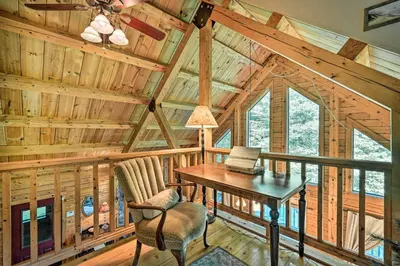 a dining room with a table and chairs in a cabin at Game Room and Hot Tub Pet-Friendly Mount Snow Gem in Dover