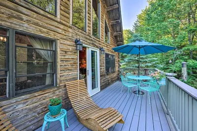 a wooden deck with a table and an umbrella at Game Room and Hot Tub Pet-Friendly Mount Snow Gem in Dover