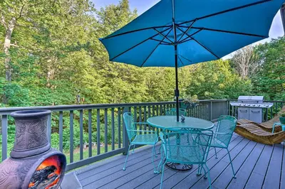 a table and chairs on a deck with an umbrella at Game Room and Hot Tub Pet-Friendly Mount Snow Gem in Dover