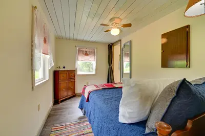 a bedroom with a bed and a ceiling fan at Quiet Country Escape Fire Pit, Fish On-Site! in Leonardsville