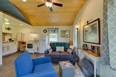 a living room with blue chairs and a couch at Quiet Country Escape Fire Pit, Fish On-Site! in Leonardsville