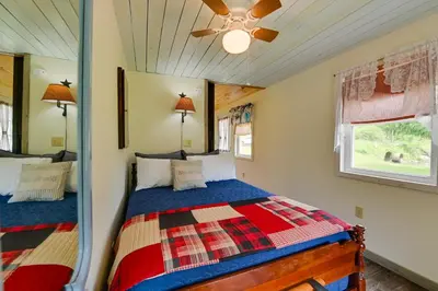a bedroom with a bed and a ceiling fan at Quiet Country Escape Fire Pit, Fish On-Site! in Leonardsville