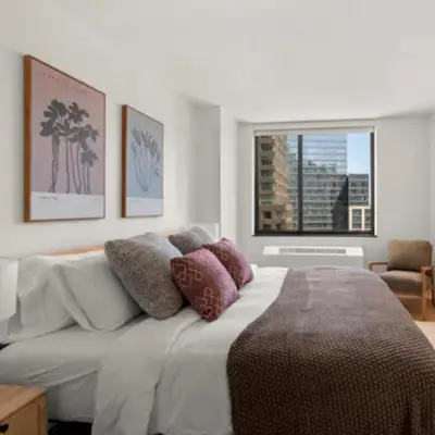 a bedroom with a bed with pillows and a window at Family Apartment in Excellent Sector of New York in New York