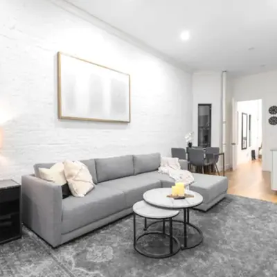 a living room with a couch and a table at Modern Holiday Apartment with Strategic Location in New York in New York