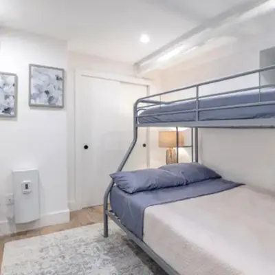 a bedroom with a bunk bed with a blue pillow at Modern Holiday Apartment with Strategic Location in New York in New York