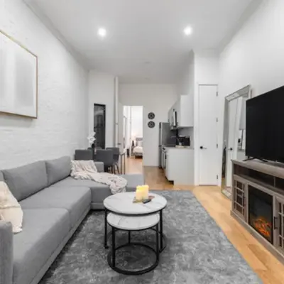 a living room with a couch and a fireplace at Modern Holiday Apartment with Strategic Location in New York in New York