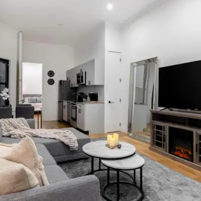 a living room with a couch and a tv at Modern Holiday Apartment with Strategic Location in New York in New York
