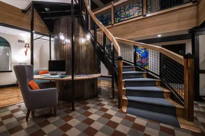 a staircase with a desk and a computer in a room at Henry Norman Hotel in Brooklyn