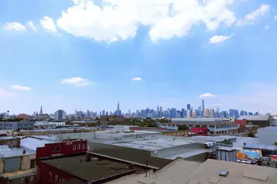 a view of the city from the roof of a building at Henry Norman Hotel in Brooklyn