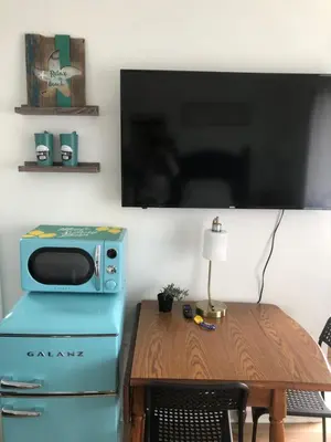 a table with a microwave on top of a blue stove at Cobmin Ridge Motel in Branchville