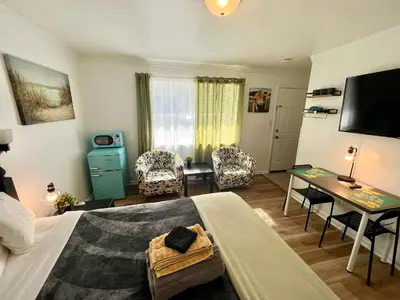 a bedroom with a bed and a table and a desk at Cobmin Ridge Motel in Branchville