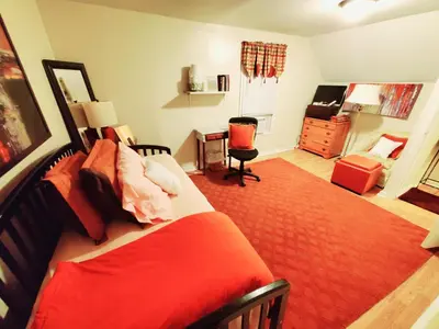 a bedroom with a large red bed and a desk at Fall Room 3min From Yale, And Other Colleges in New Haven