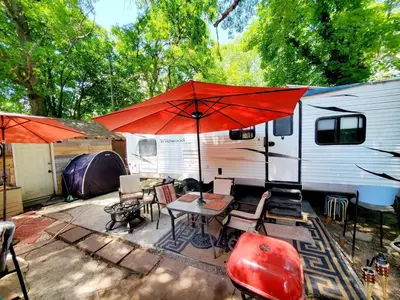 a patio with a table and an umbrella and a trailer at Fall Room 3min From Yale, And Other Colleges in New Haven