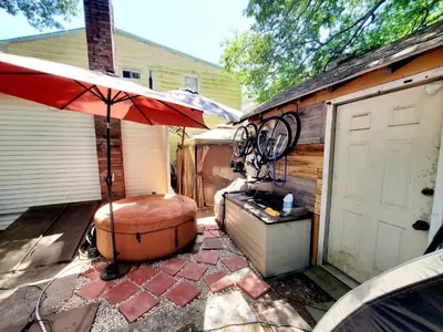 a patio with an umbrella next to a garage at Fall Room 3min From Yale, And Other Colleges in New Haven